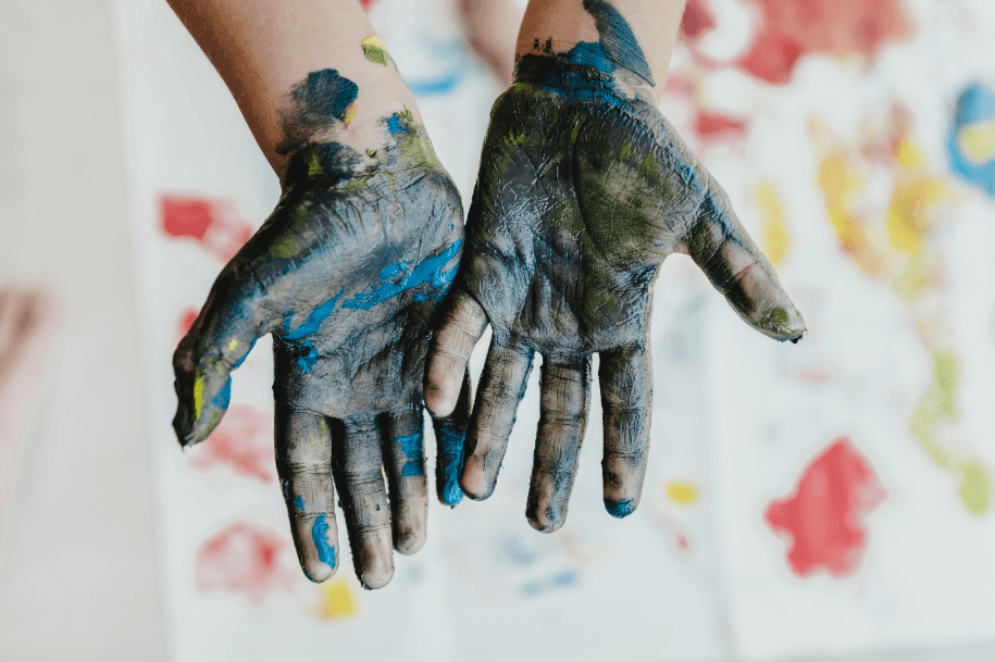 messy hands with DIY decor wall art