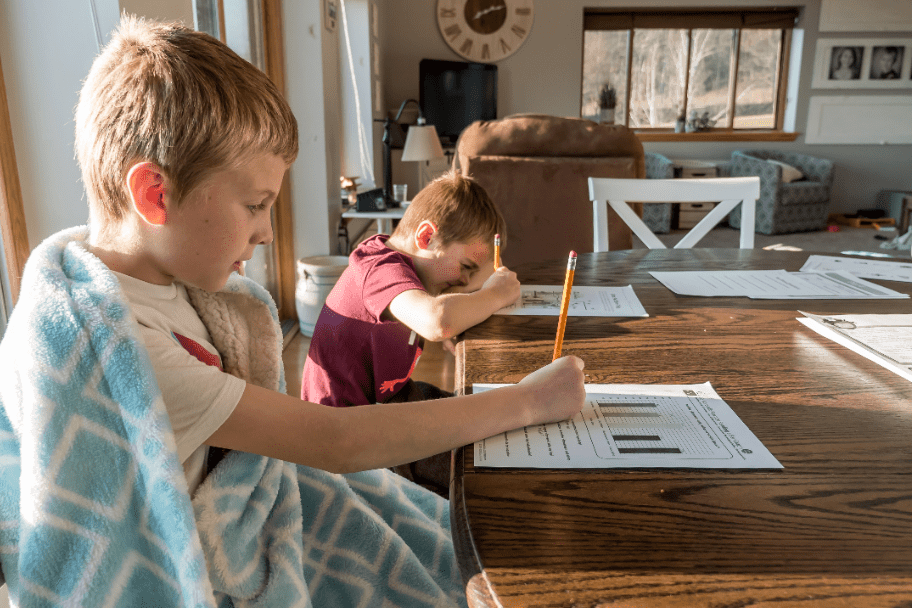 homeschool children sitting at writing desks