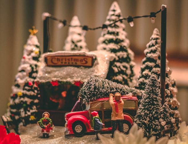 winter decor setting with christmas trees and people