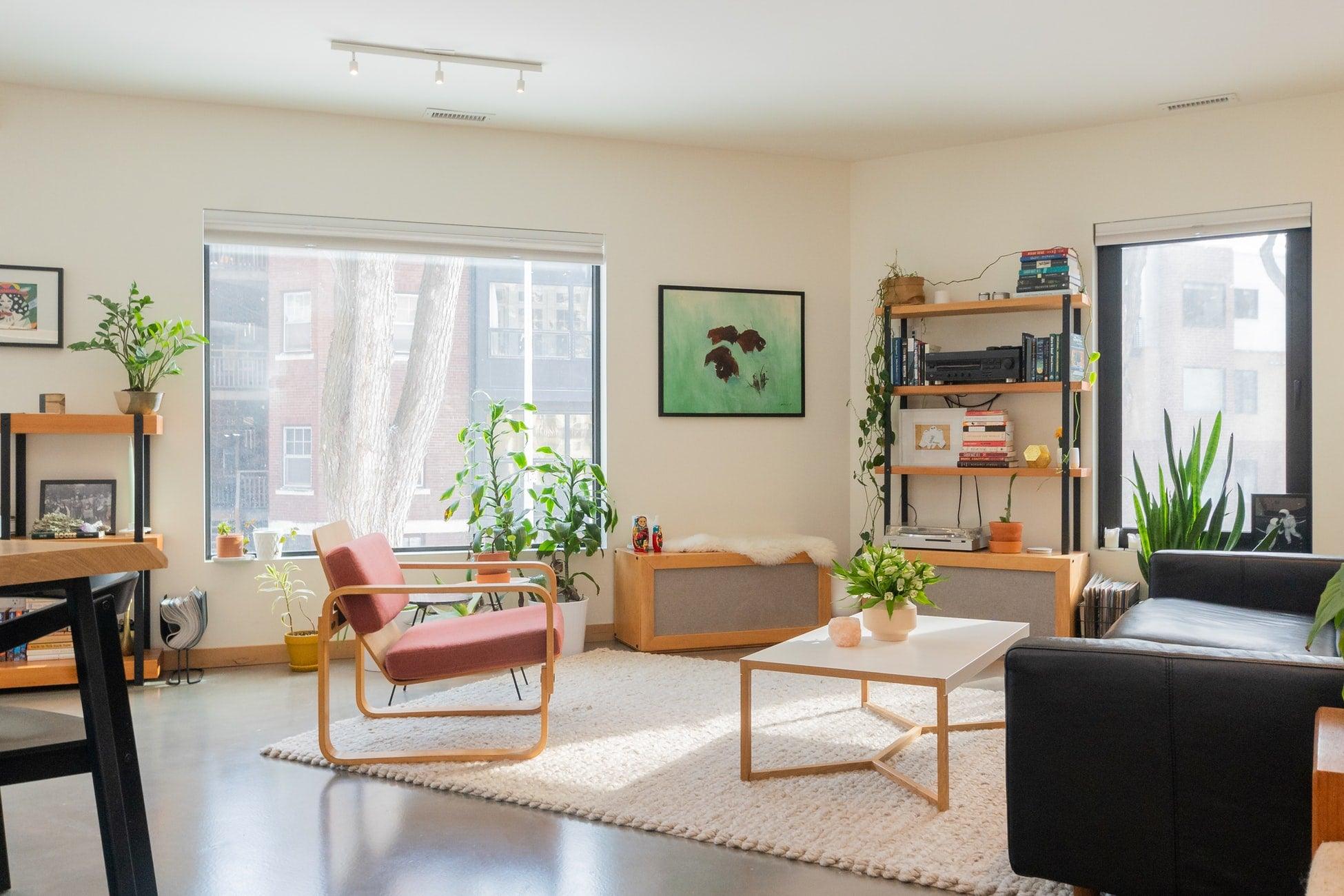 A naturally lit living room with minimalist furniture and subtle decoration.