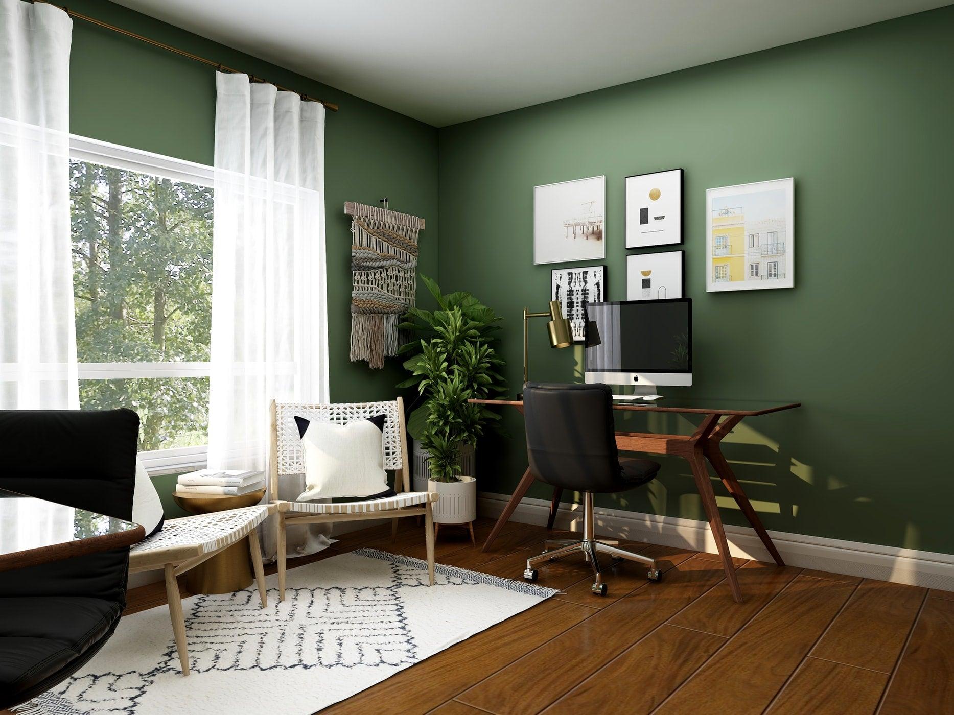 A beautiful home office with wooden desk, a leather chair, and a big monitor.