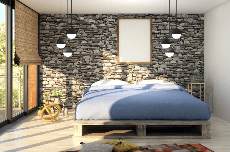 A wooden bed with a thick mattress with blue upholstery and while pillows